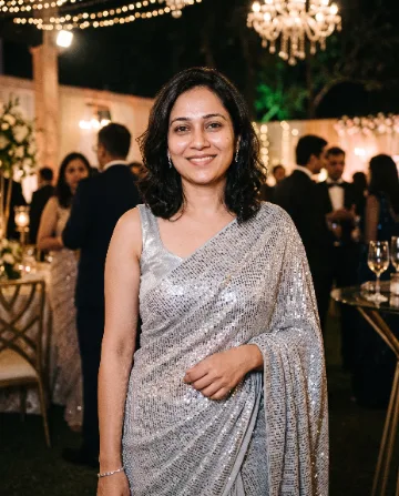 AI saree photo of the same woman in a silver sequinned saree at an evening party
